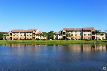 Lake near buildings and grass